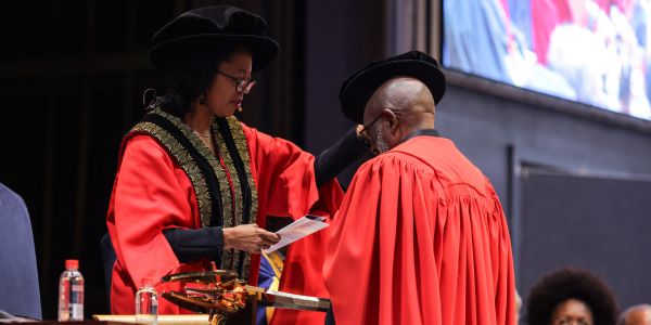 Dr Judy Dlamini, Chancellor confers Honorary Doctorate Degree on Professor Loyiso Gordon Nongxa.